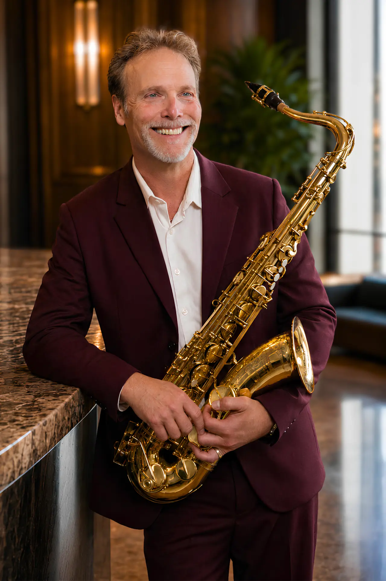 Howard Anderson holding his saxophone in a refined lounge setting